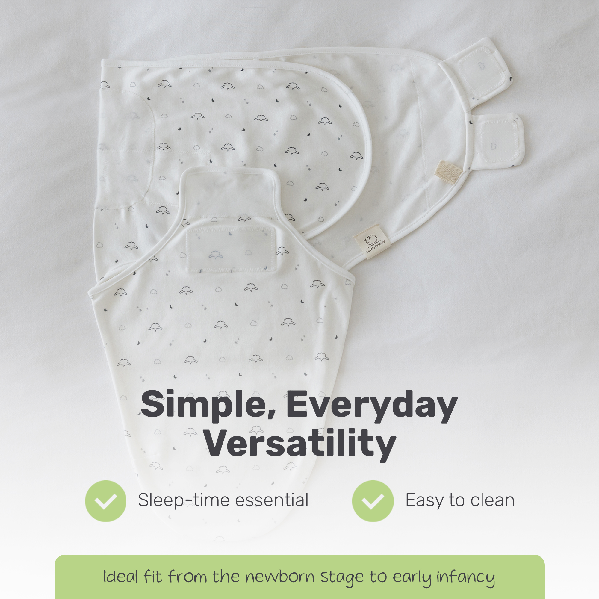 White swaddle wrap with gray sheep and moon prints laid flat, showing its shape and fasteners